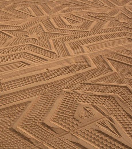 These are the real Imprints Of the Tires Of A Groomer On Sand
