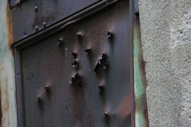 Bullet holes in the door.