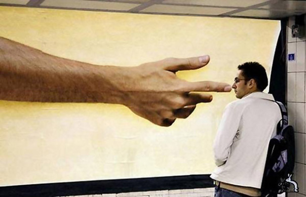 A big hand pointing a man