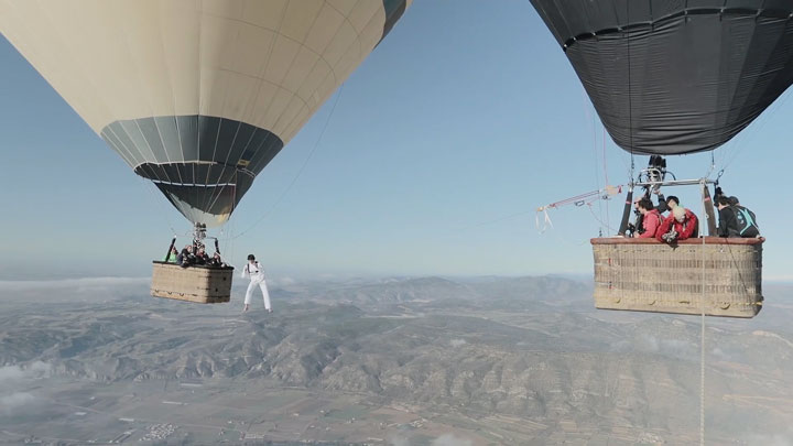 Amazing Stunt Of Walking On A Tightrope Between Two Air Balloons Above Clouds-1