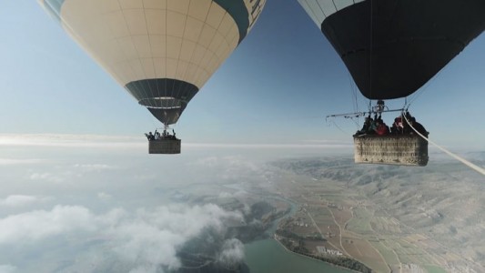 Amazing Stunt Of Walking On A Tightrope Between Two Air Balloons Above Clouds-4