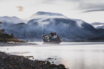 An Abandoned Boat With The Highest Mountain Of UK In Back Ground